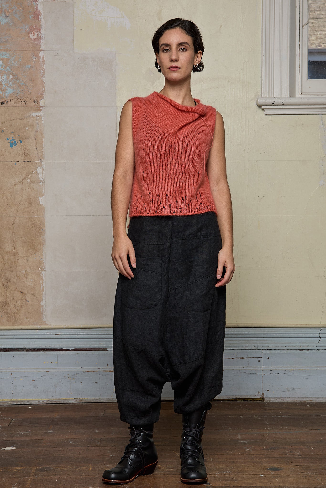 Front view of model wearing super lush knitted vest in carrot colourway, designed and knitted in Melbourne by Wendy Voon knits