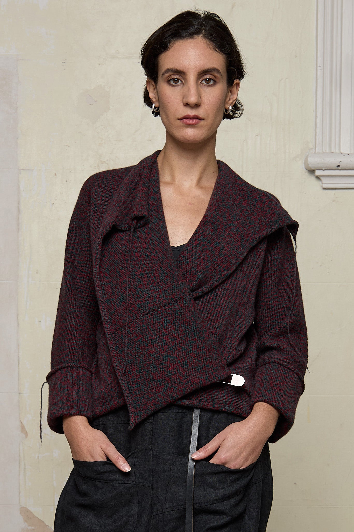 Front view of knitted wool cropped jacket in red and teal melange, designed by Wendy Voon, knitted in Melbourne.