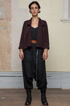 Front view of knitted wool cropped jacket in red and teal melange, designed by Wendy Voon, knitted in Melbourne.