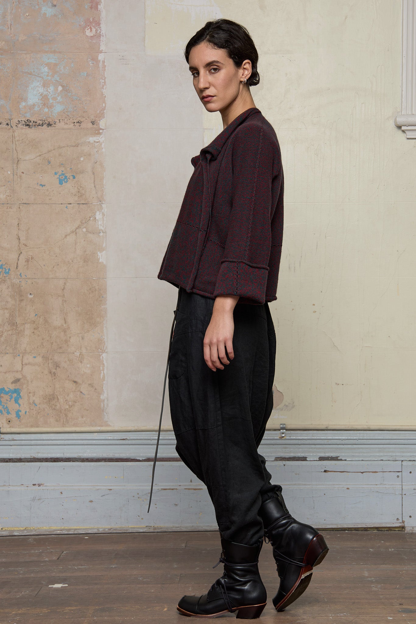Side view of knitted wool cropped jacket in red and teal melange, designed by Wendy Voon, knitted in Melbourne.