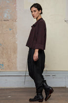 Side view of knitted wool cropped jacket in red and teal melange, designed by Wendy Voon, knitted in Melbourne.