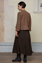 Back view of knitted wool cropped jacket in rust, army and cream melange, designed by Wendy Voon, knitted in Melbourne.