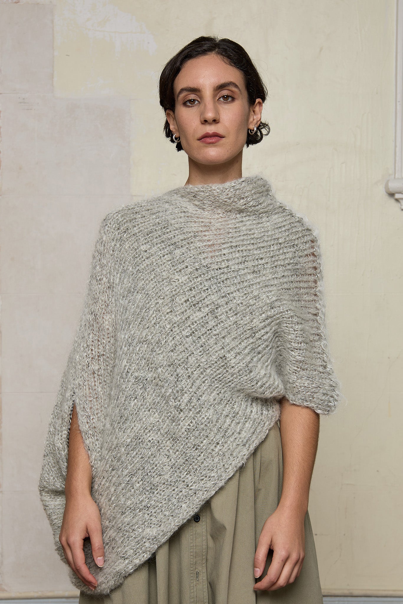 Front view of model wearing mohair cocoon, an asymmetric poncho in a white flecked colourway