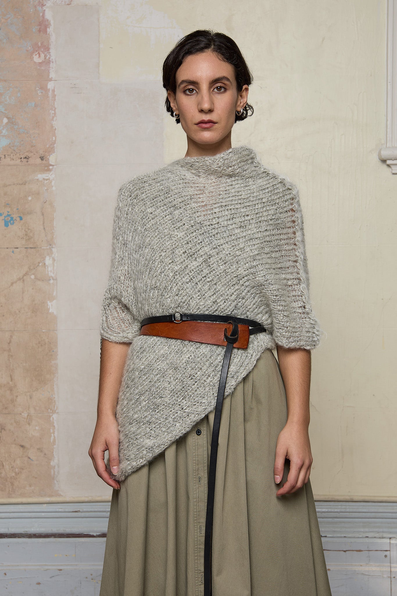 Front view of model wearing mohair cocoon belted, an asymmetric poncho in a white flecked colourway