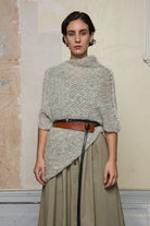Front view of model wearing mohair cocoon belted, an asymmetric poncho in a white flecked colourway