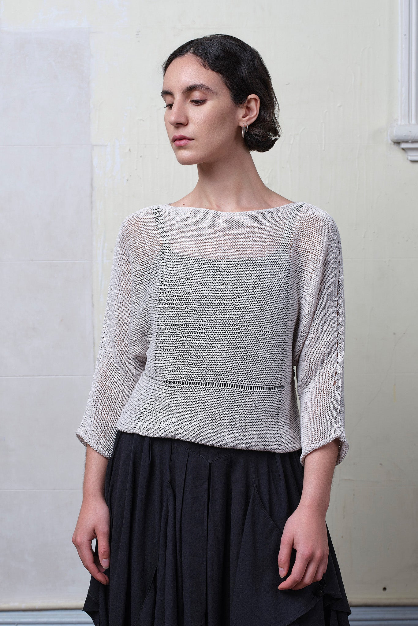 Model wears an open knitted linen/cotton batwing jumper in pearl colourway, designed and knitted in Melbourne by Wendy Voon knits.
