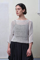 Model wears an open knitted linen/cotton batwing jumper in pearl colourway, designed and knitted in Melbourne by Wendy Voon knits.