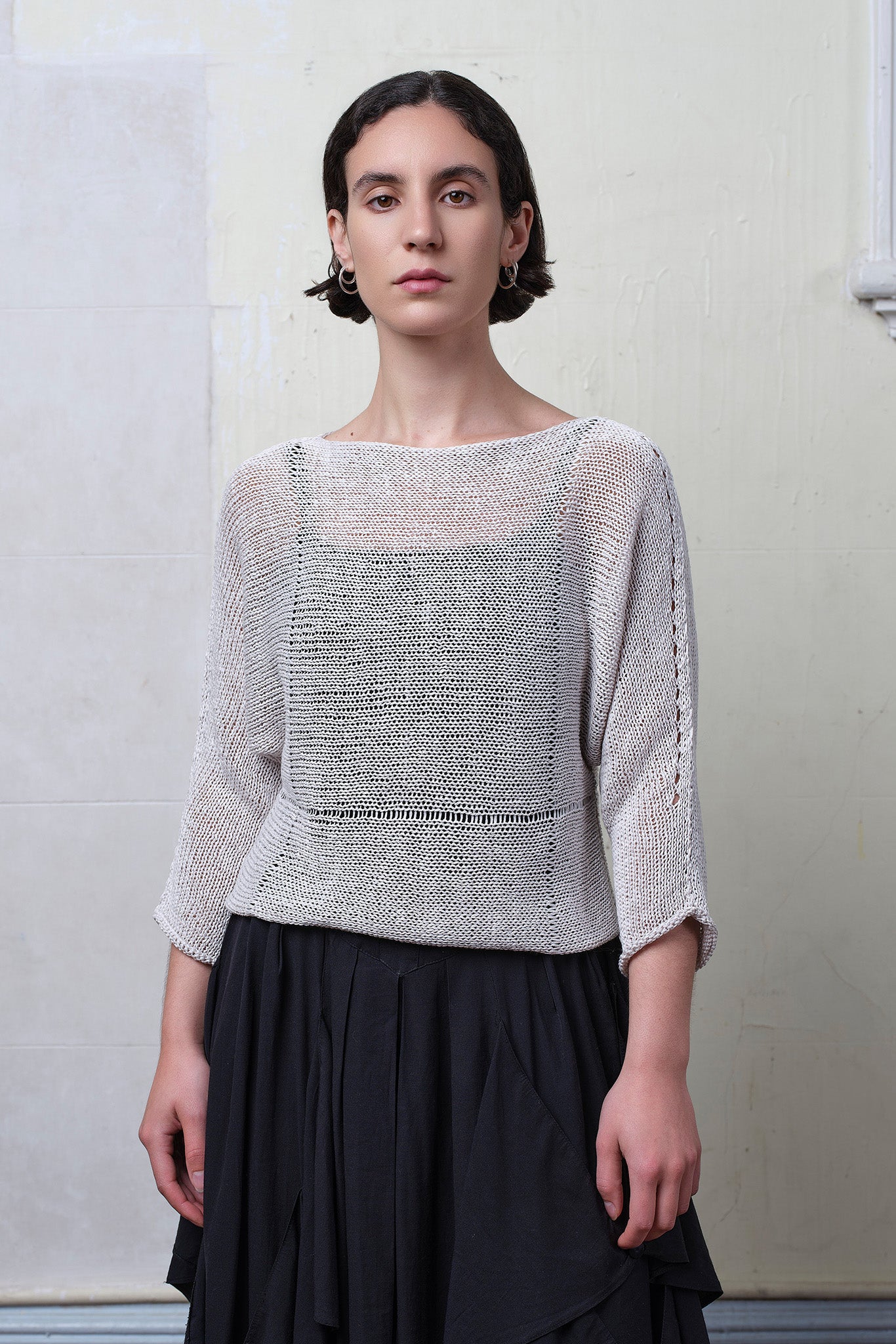 Model wears an open knitted linen/cotton batwing jumper in pearl colourway, designed and knitted in Melbourne by Wendy Voon knits.