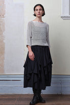 Model wears an open knitted linen/cotton batwing jumper in pearl colourway, designed and knitted in Melbourne by Wendy Voon knits.