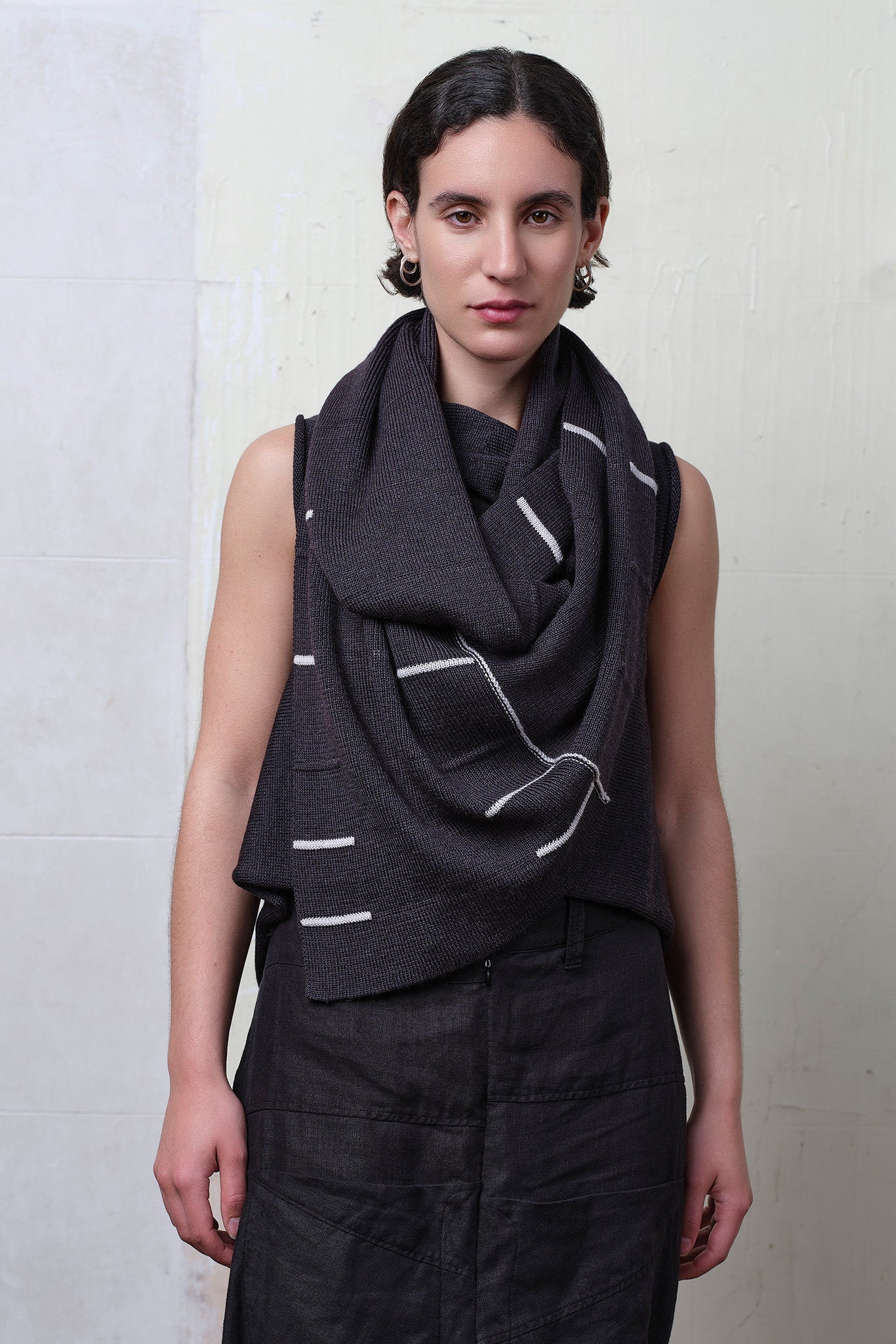Model wears superfine merino linework scarf featuring off white stripe detail on charcoal. Designed and knitted in Melbourne by Wendy Voon knits