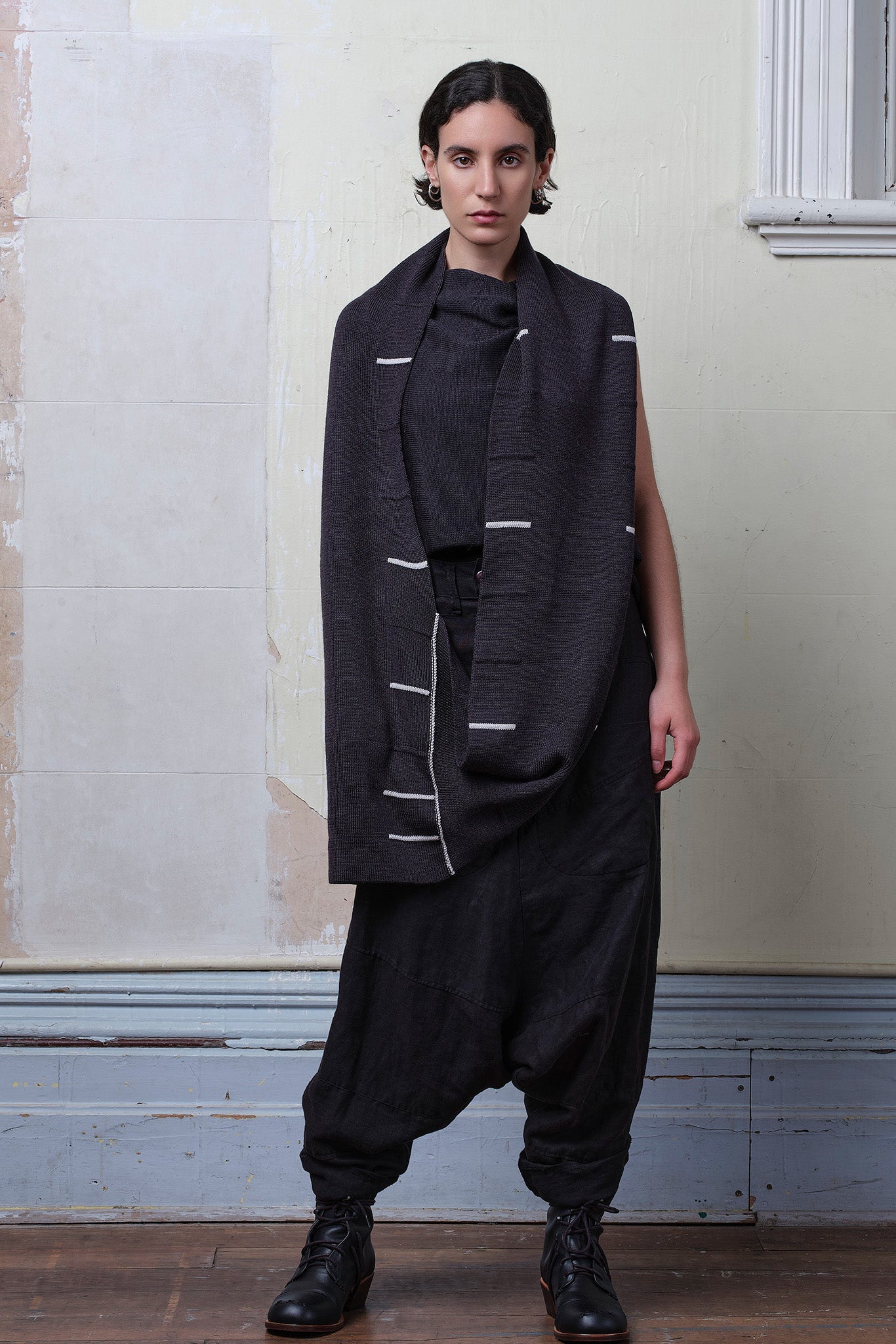 Model wears superfine merino linework scarf featuring off white stripe detail on charcoal. Designed and knitted in Melbourne by Wendy Voon knits