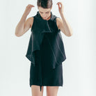 Front full length view of Two Toned Self Curling vest design by Wendy Voon knits in charcoal and black merino wool