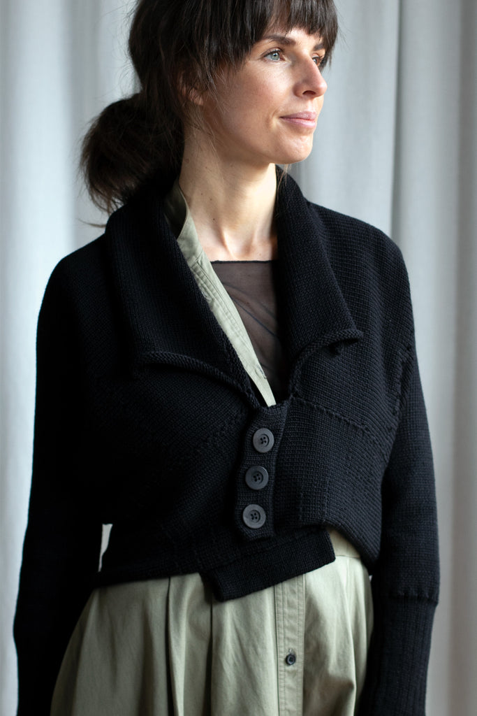 Front view of Chunky Knit Cardigan design by Wendy Voon in black merino wool with black buttons worn closed