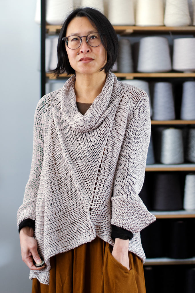 Front view of dusty coloured open knit cotton jumper with funnel neck, designed and knitted by Wendy Voon