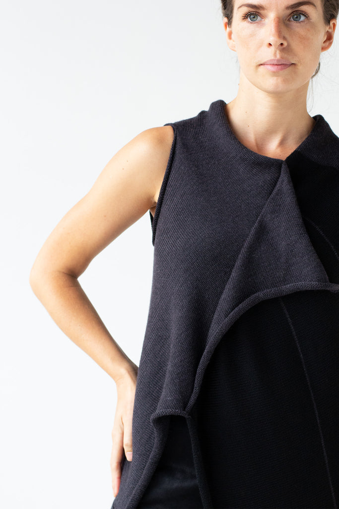 Front detail view of Two Toned Asymmetric Longline vest by Wendy Voon knits in charcoal and black, showing contrast stripes