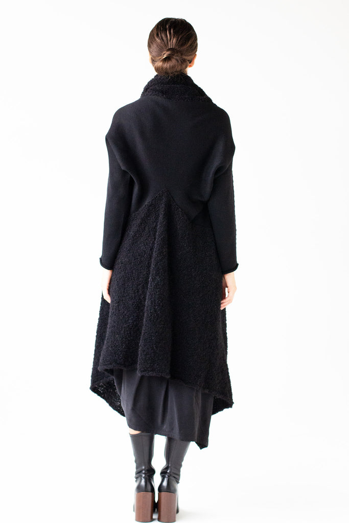 Full length back view of Logical Progression Coat by Wendy Voon in black merino and alpaca, showing V shape waist detail