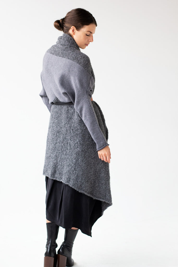 Side back view of Logical Progression Coat by Wendy Voon in storm grey merino and alpaca, worn long and belted at waist