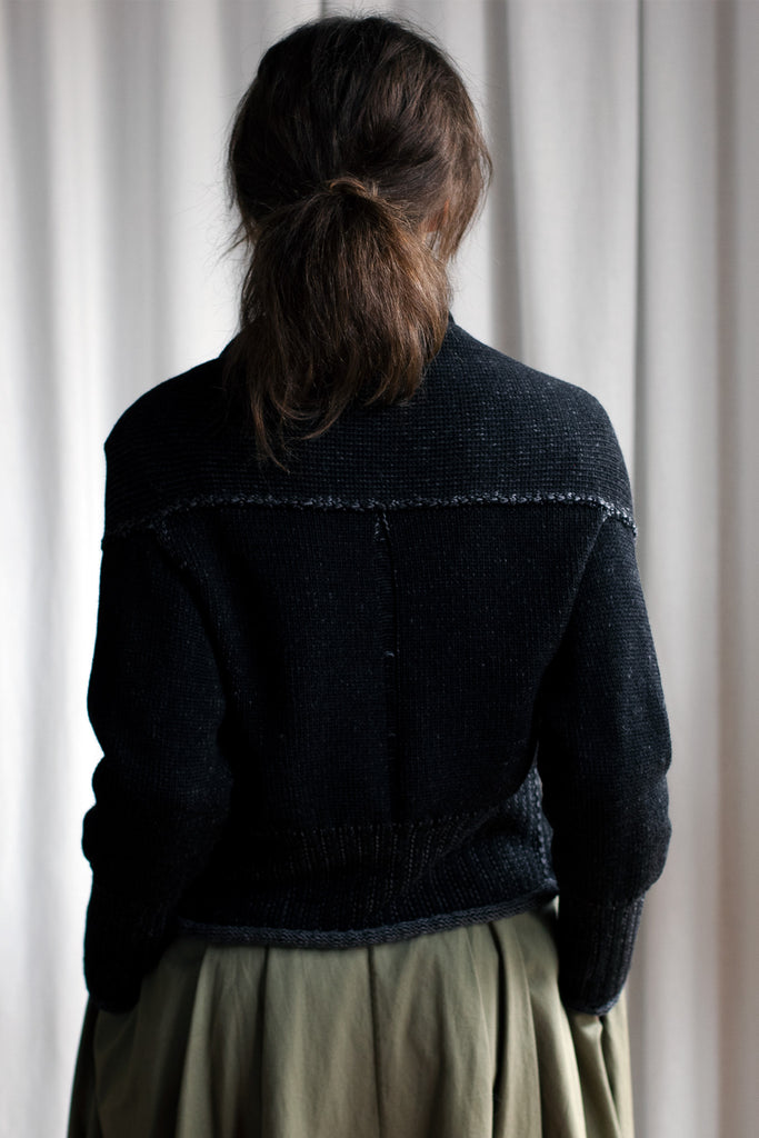 Back view of black flecked chunky knit cardigan, with ruched detail around neck, designed and made by Wendy Voon knits