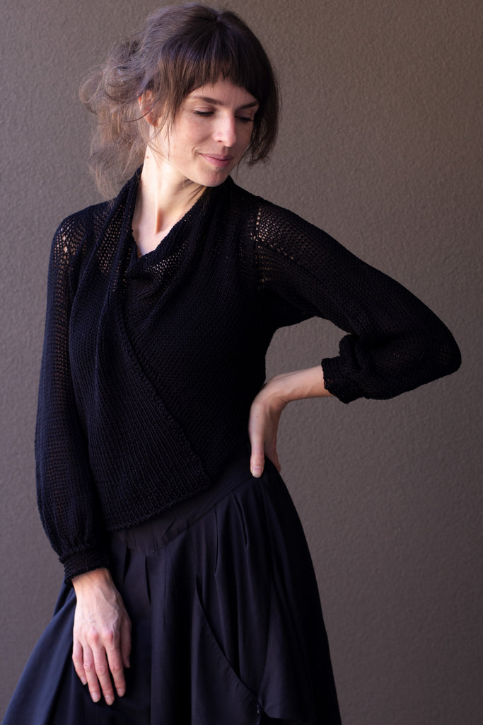 Front profile of model wearing black cotton cowl neck jumper, designed  and knitted in Melbourne by Wendy Voon knits
