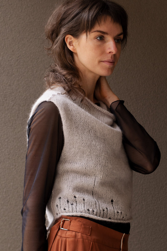 Side view of super soft knitted vest in a dust of pink colourway, featuring laddered laceholes, made from baby alpaca, mohair and silk. Designed and made in Melbourne by Wendy Voon knits