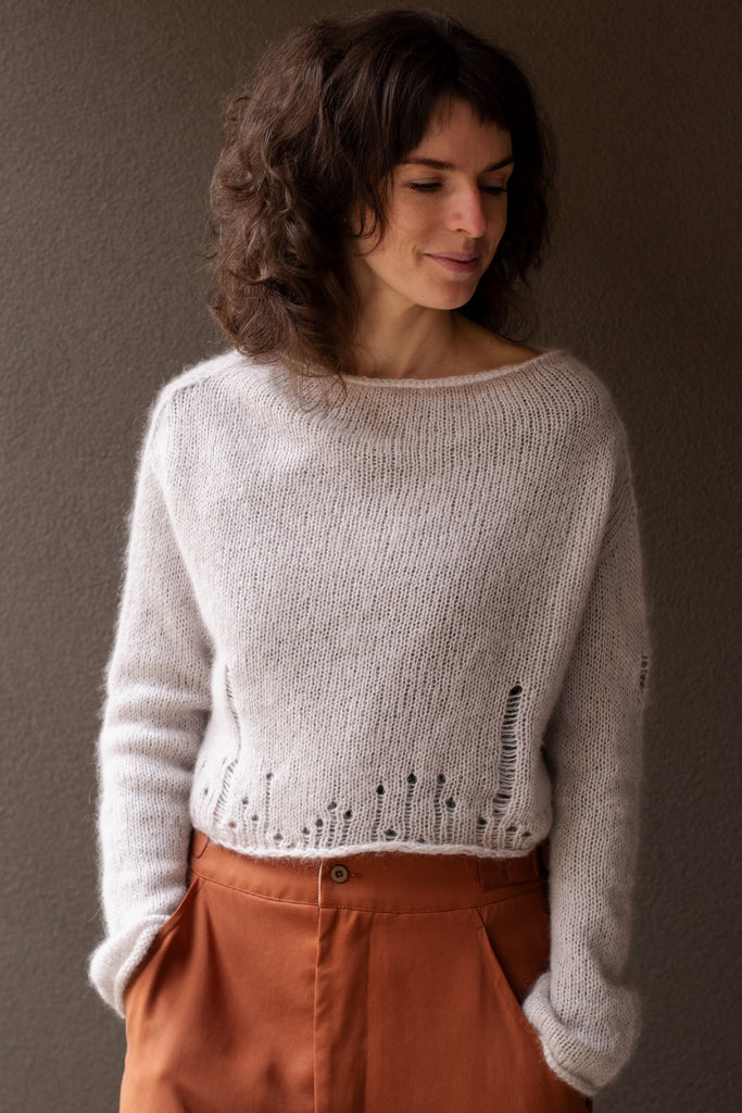 Front view of super soft knitted jumper in a dust of pink colourway, featuring laddered laceholes, made from baby alpaca, mohair and silk. Designed and made in Melbourne by Wendy Voon knits