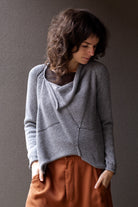 Front view of  superfine merino wool/polyamide soft grey jumper, designed by Wendy Voon knits, made in Melbourne.  Jumper features triangular panels at front with loose threads left as design feature
