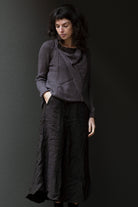 Front view of taupe superfine merino wool/polyamide jumper, designed by Wendy Voon knits, made in Melbourne.  Jumper features triangular panels at front with loose threads left as design feature