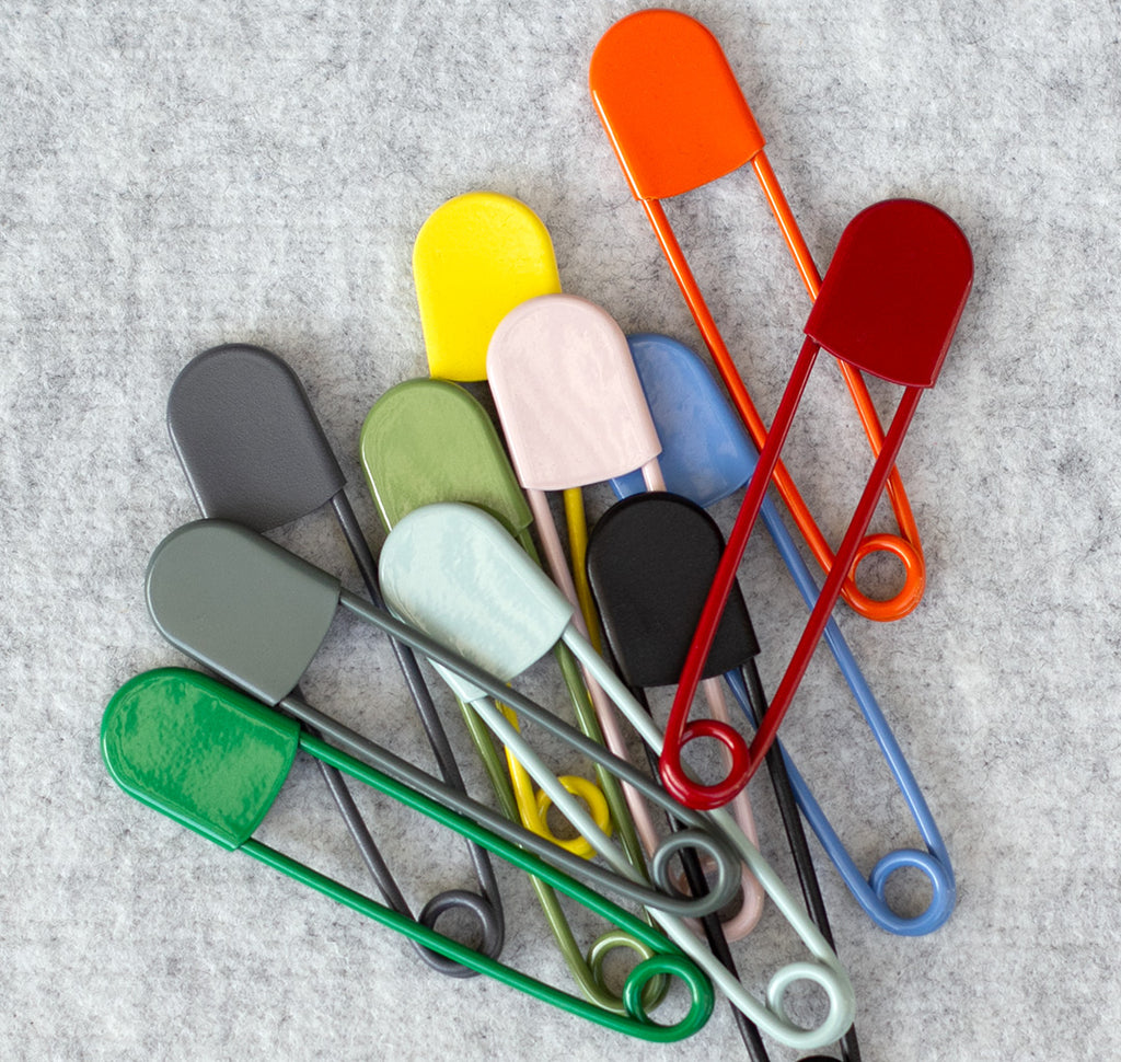Group of colourful giant safety pins
