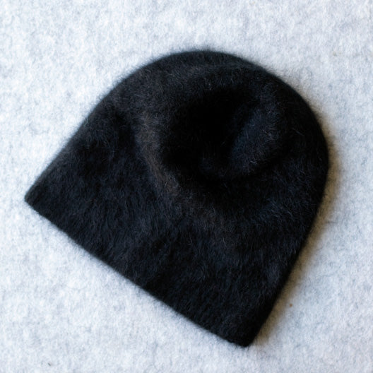 Black coloured knitted beanie made from merino wool, possum and silk