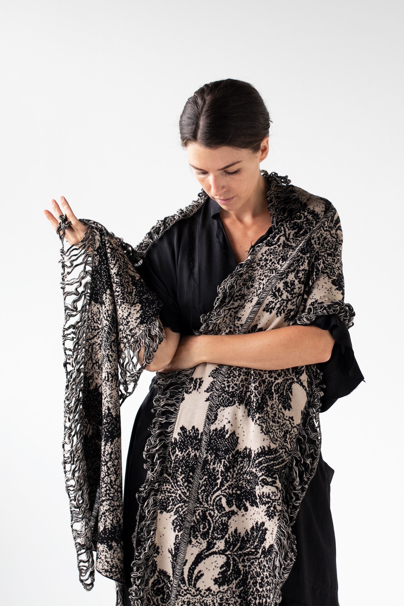 Front silhouette view of black and pearl colour knitted Damask Scarf design by Wendy Voon in merino wool, linen and cotton