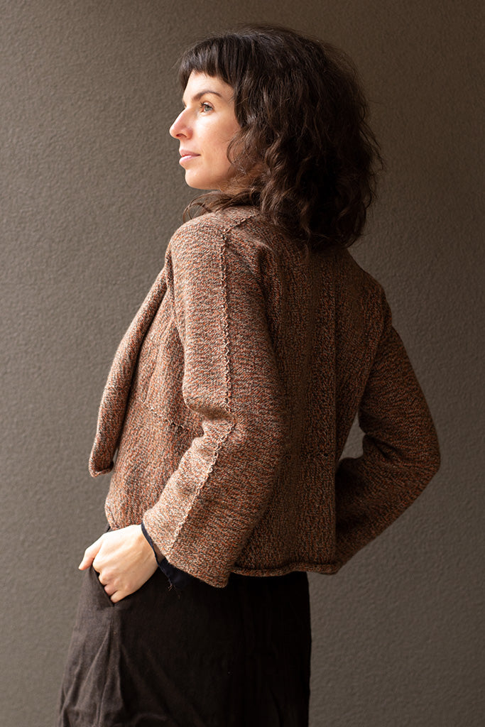 Back view of knitted wool cropped jacket in rust, army and cream melange, designed by Wendy Voon, knitted in Melbourne.
