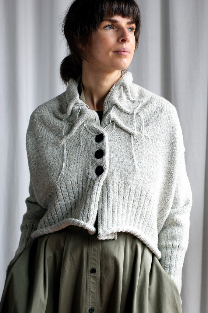 Front view of off white superfine merino wool cardi, with ruched detail around the neck, designed and made by Wendy Voon knits.