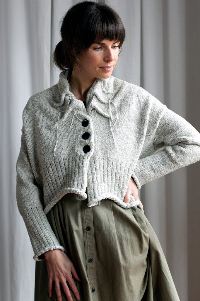 Front view of off white superfine merino wool cardi, with ruched detail around the neck, designed and made by Wendy Voon knits.