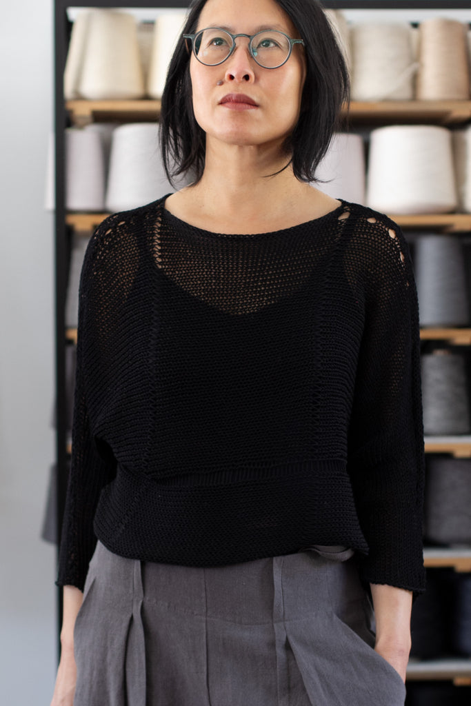 Front view of Cotton Batwing  in black colourway, featuring lace details along garment seam,  designed by Wendy Voon knits.