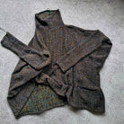Dark gray textured sweater on a gray surface