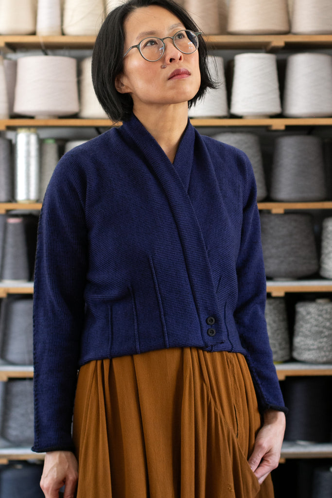 Front view of welted wool cardigan buttoned up in blue/black colourway