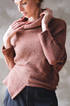 Model wears wool bias knit jumper in terracotta flecked colourway.