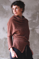 Model wears wool bias knit jumper in terracotta flecked colourway.