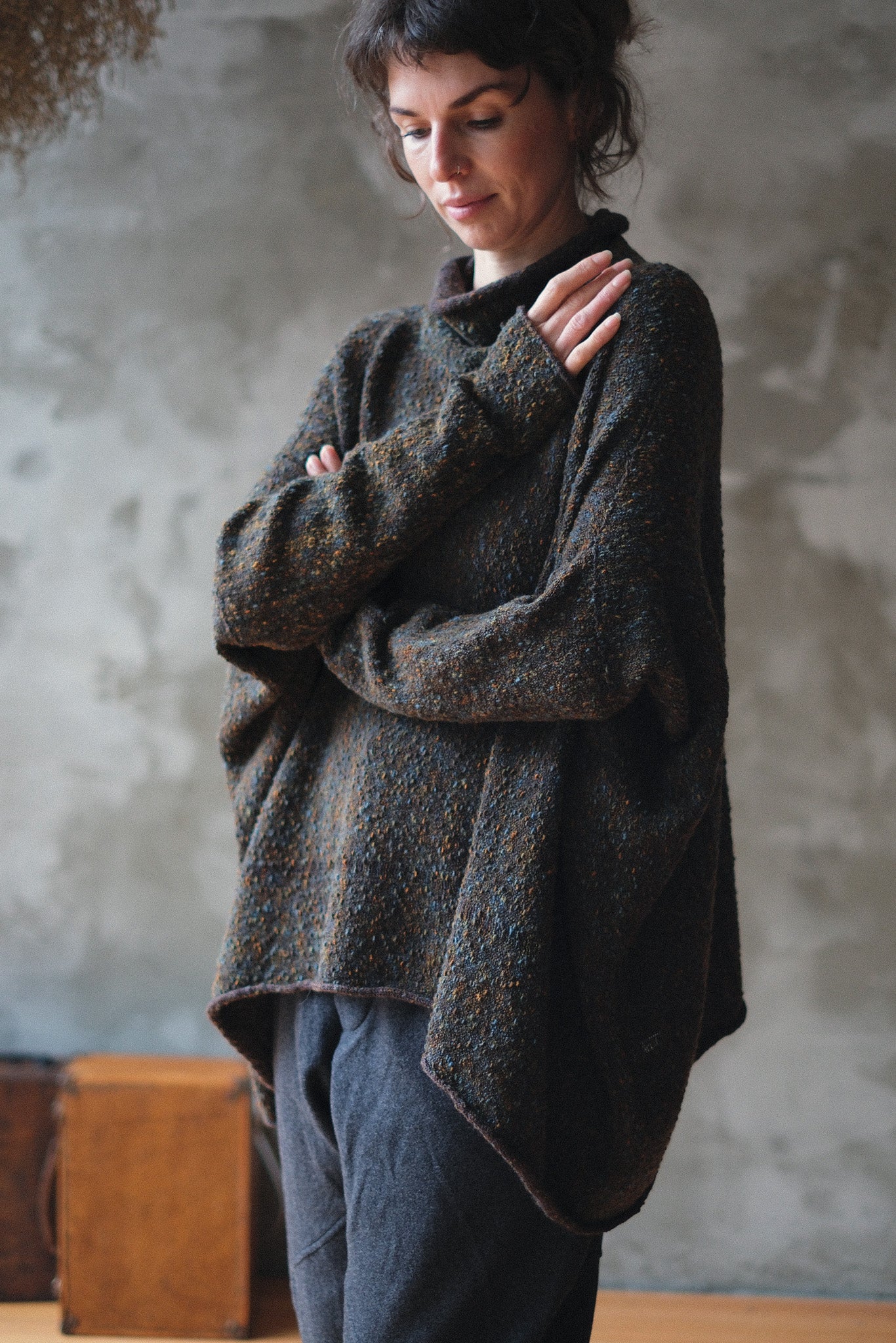 Model wears brown flecked jumper inside out, made from superfine merino wool, designed and made in Melbourne by Wendy Voon knits.