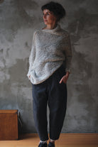 Model wears a mohair cocoon sleeved jumper in a natural colour.