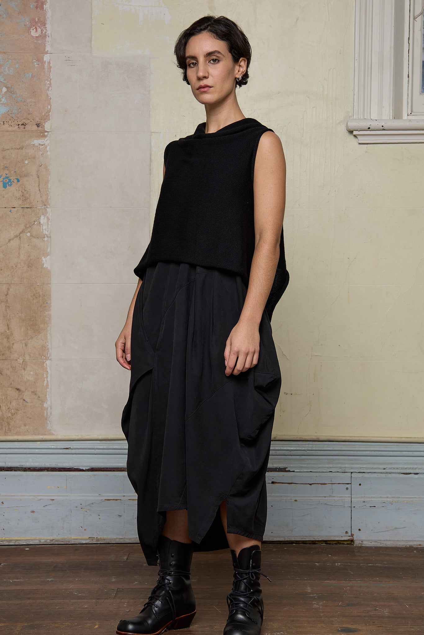 Model wears black knitted asymmetric vest back to front. Designed and knitted in Melbourne by Wendy Voon knits