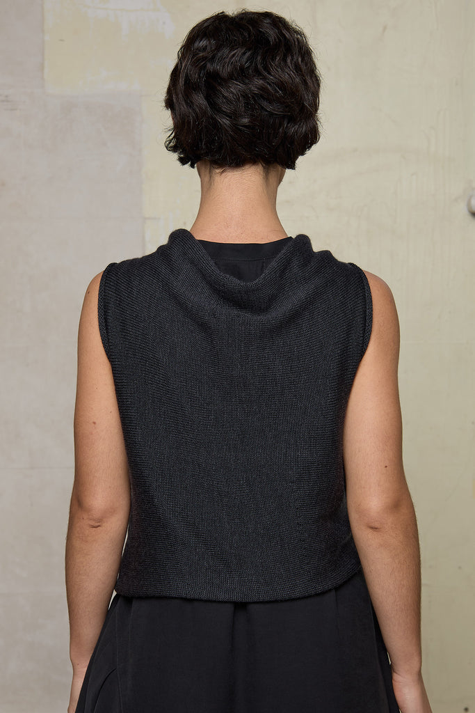 Model wears knitted charcoal asymmetric self curling vest. Designed and knitted in Melbourne by Wendy Voon knits