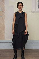 Model wears knitted charcoal asymmetric self curling vest. Designed and knitted in Melbourne by Wendy Voon knits