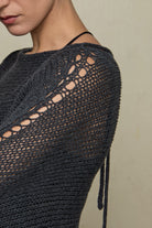Close up of fabric of loose cord knit batwing in charcoal, designed by Wendy Voon knits and made in Melbourne.
