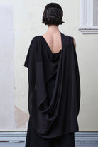 Back view of model wearing a striped wrap flipped on its side, in charcoal/black colourway. Designed and made in Melbourne by Wendy Voon knits.