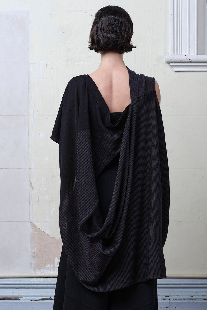 Back view of model wearing a striped wrap flipped on its side, in charcoal/black colourway. Designed and made in Melbourne by Wendy Voon knits.