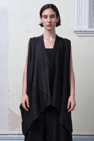 Model wearing a wool striped wrap in charcoal/black colourway. Designed and made in Melbourne by Wendy Voon knits.