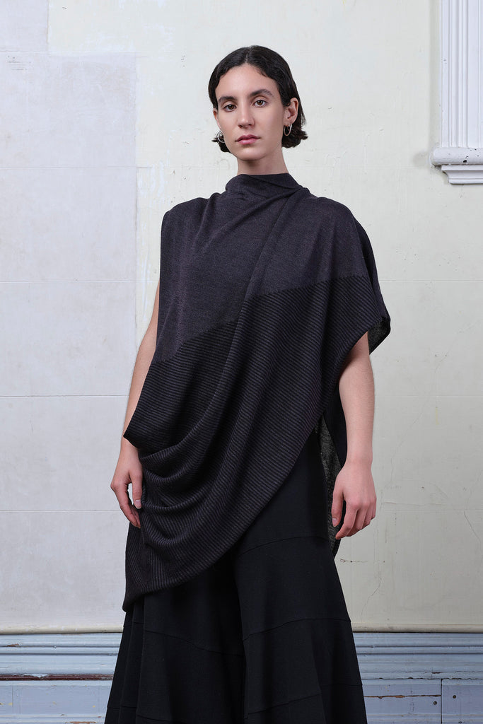 Model wears striped wrap flipped on its side, in charcoal/black colourway. Designed and made in Melbourne by Wendy Voon knits.