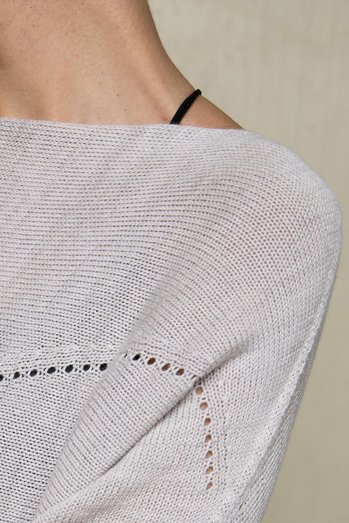 Close up fabric view of  a natural coloured knitted batwing, designed and knitted in Melbourne by Wendy Voon knits