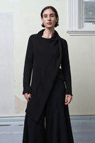 Model wears knitted merino cross over, in black colourway.